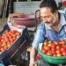 A vendor sorts tomatoes at a market, in Nagpur on Thursday.